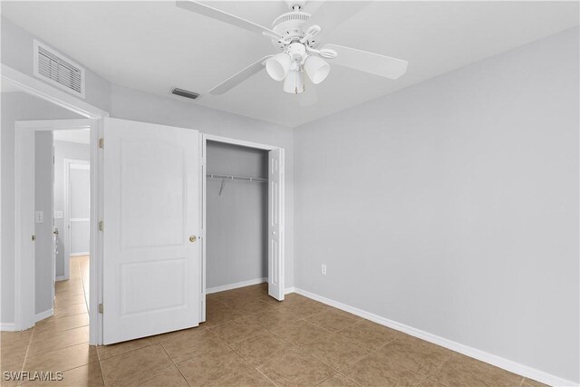 821 Casino Ave, Lehigh Acres, FL 33971 - unfurnished bedroom featuring tile patterned flooring, baseboards, a closet, and ceiling fan