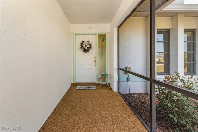 entrance to property with stucco siding