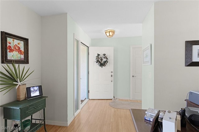 entryway with light wood-style floors and baseboards