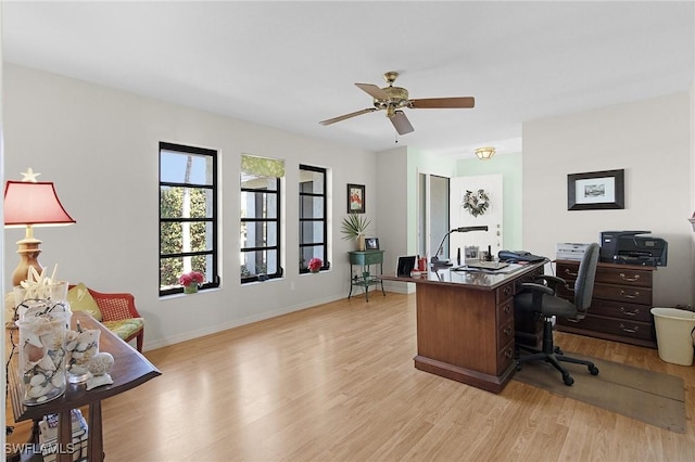 office space with light wood-style flooring, baseboards, and a ceiling fan