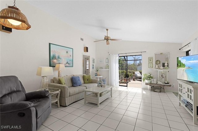 living area with light tile patterned floors, a ceiling fan, and high vaulted ceiling