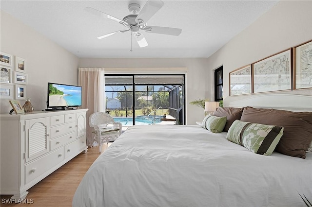 bedroom featuring light wood-style flooring, a ceiling fan, and access to outside