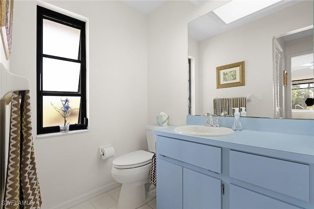 bathroom with tile patterned flooring, toilet, vanity, and baseboards