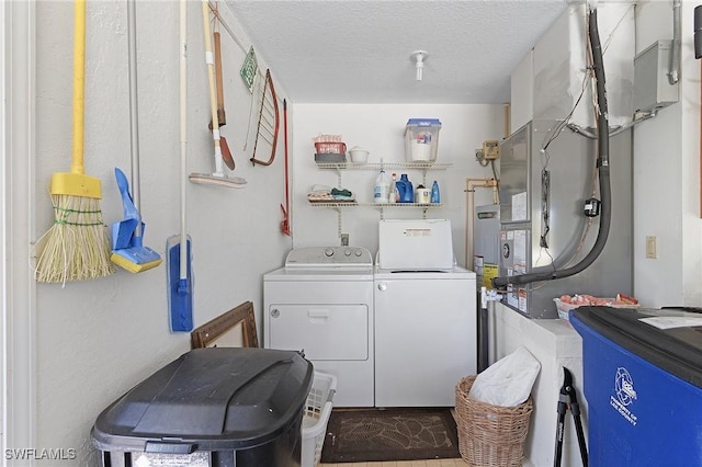 laundry area with laundry area, washing machine and dryer, and a textured ceiling