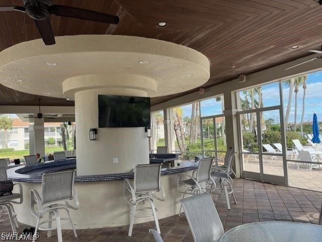 exterior space featuring a lanai, outdoor wet bar, and a ceiling fan