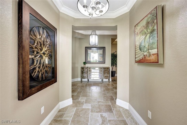 9293 Menaggio Ct Unit 102, Naples, FL 34114 - hallway featuring ornamental molding, baseboards, a chandelier, and stone tile flooring