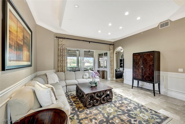 9293 Menaggio Ct Unit 102, Naples, FL 34114 - living area with visible vents, a wainscoted wall, ornamental molding, stone finish floor, and arched walkways