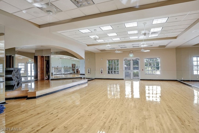 9293 Menaggio Ct Unit 102, Naples, FL 34114 - workout room with wood finished floors, visible vents, baseboards, arched walkways, and a drop ceiling