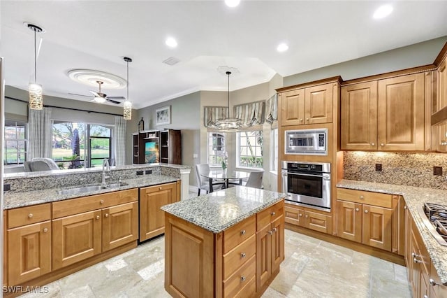 9293 Menaggio Ct Unit 102, Naples, FL 34114 - kitchen featuring visible vents, a kitchen island, ceiling fan, a sink, and appliances with stainless steel finishes