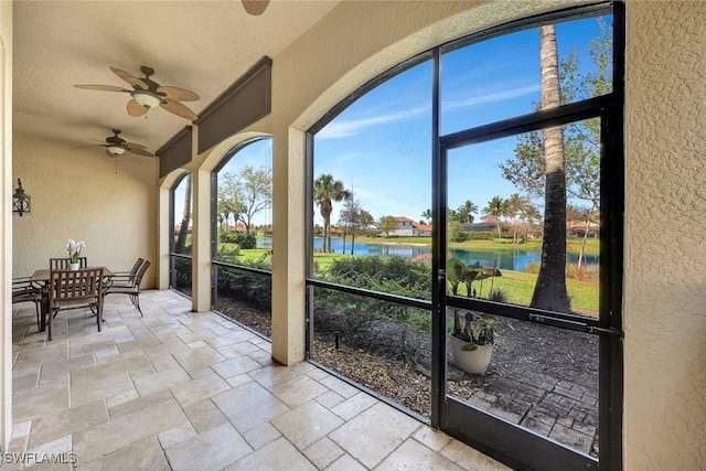9293 Menaggio Ct Unit 102, Naples, FL 34114 - unfurnished sunroom featuring a ceiling fan and a water view