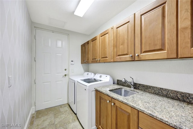 9293 Menaggio Ct Unit 102, Naples, FL 34114 - laundry room featuring baseboards, cabinet space, a sink, stone finish flooring, and washer and dryer