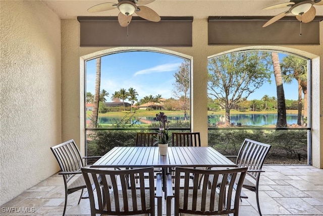 9293 Menaggio Ct Unit 102, Naples, FL 34114 - view of patio with outdoor dining area, a water view, and ceiling fan