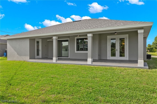 back of house featuring stucco siding, french doors, a yard, roof with shingles, and ceiling fan