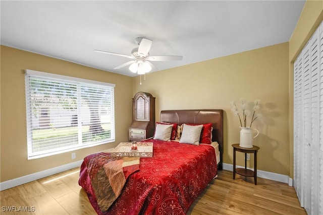 bedroom featuring a ceiling fan, wood finished floors, and baseboards