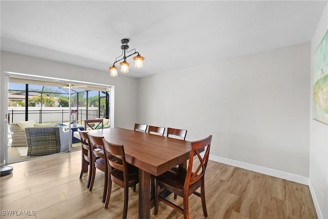 dining area with light wood finished floors and baseboards