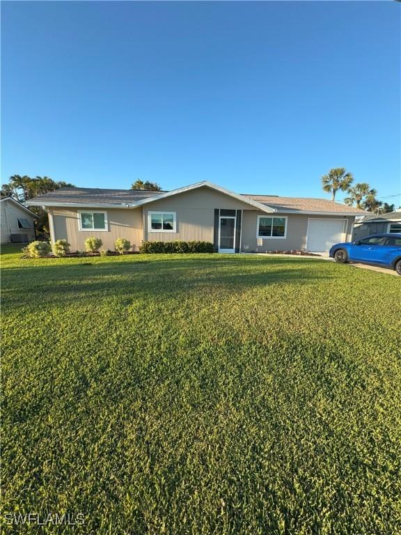 single story home with a front lawn and an attached garage