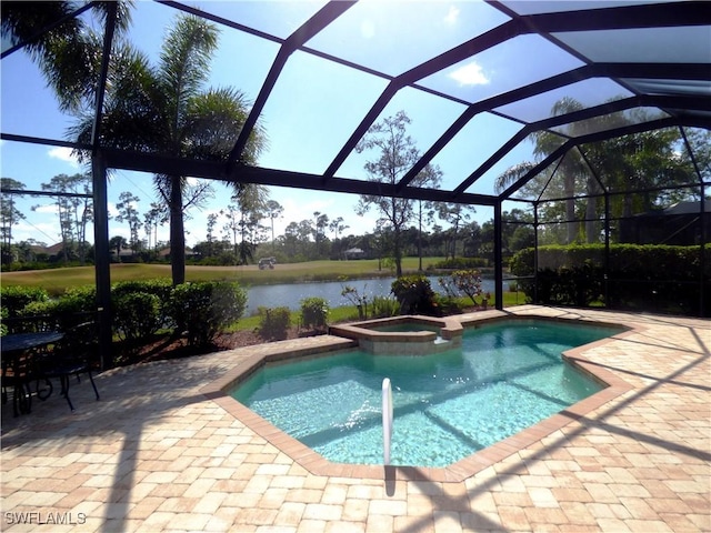 view of swimming pool featuring glass enclosure, a water view, a pool with connected hot tub, and a patio area