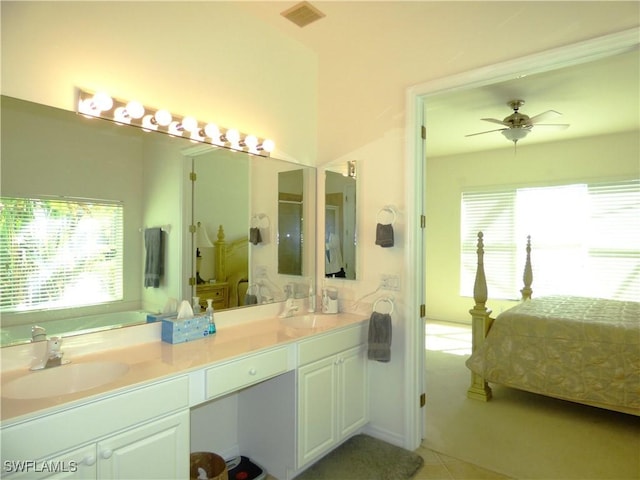 ensuite bathroom with visible vents, ensuite bath, double vanity, ceiling fan, and a sink