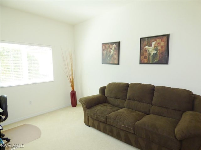 carpeted living room featuring baseboards