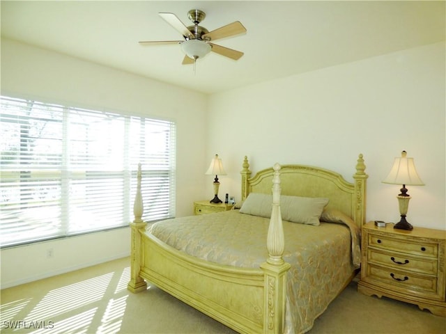 bedroom with a ceiling fan and carpet