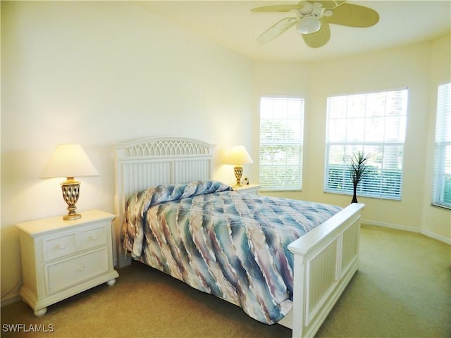 carpeted bedroom with baseboards and ceiling fan