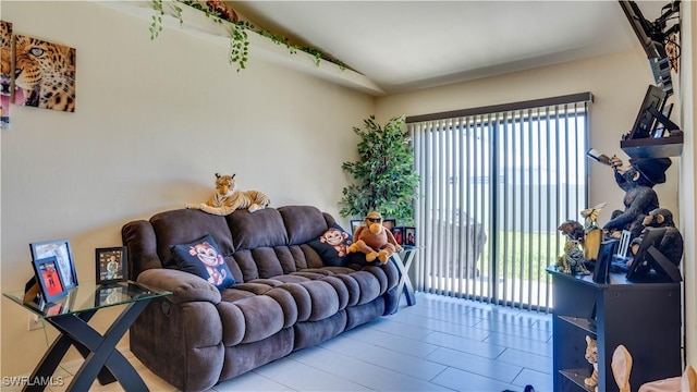 living area featuring plenty of natural light and lofted ceiling
