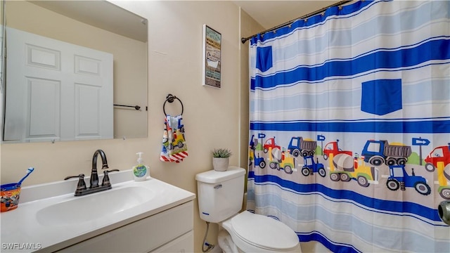 bathroom featuring toilet, vanity, and a shower with shower curtain