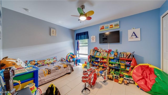 recreation room featuring tile patterned floors and a ceiling fan