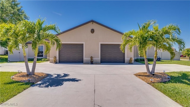 view of front of property featuring stucco siding, an attached garage, and concrete driveway
