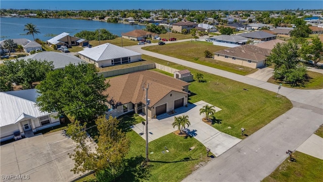 birds eye view of property featuring a water view and a residential view
