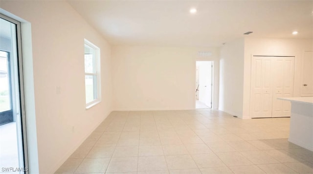 empty room with visible vents, light tile patterned floors, recessed lighting, and baseboards