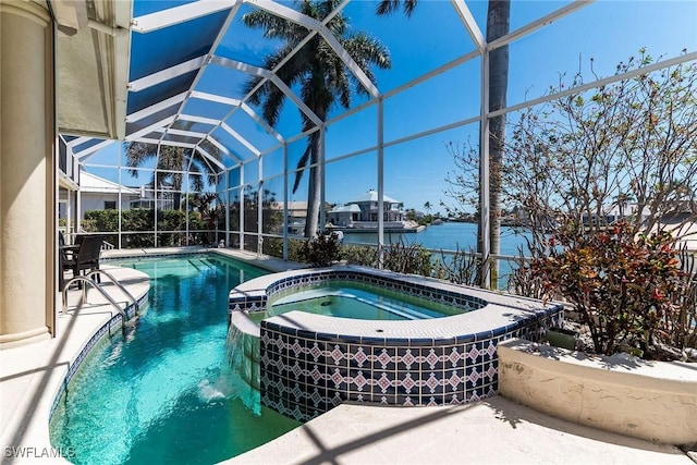 view of swimming pool featuring glass enclosure, a patio, a water view, and a pool with connected hot tub