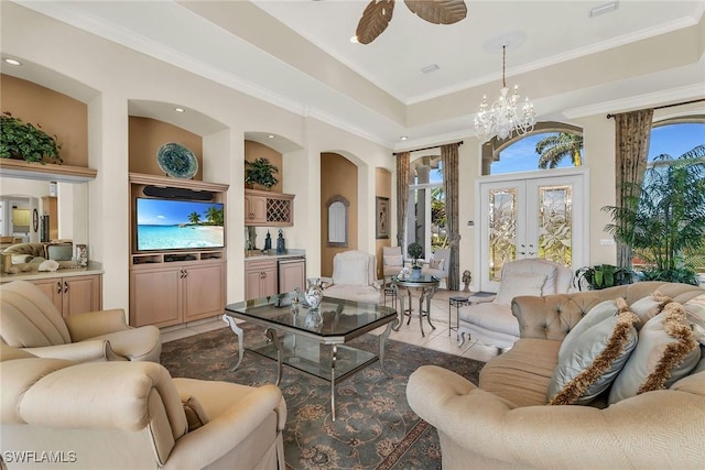 living room featuring a raised ceiling, arched walkways, and ornamental molding