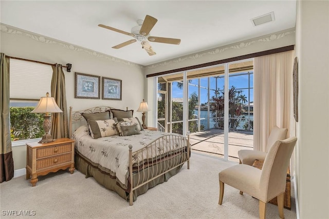 bedroom with a ceiling fan, access to outside, light colored carpet, and visible vents