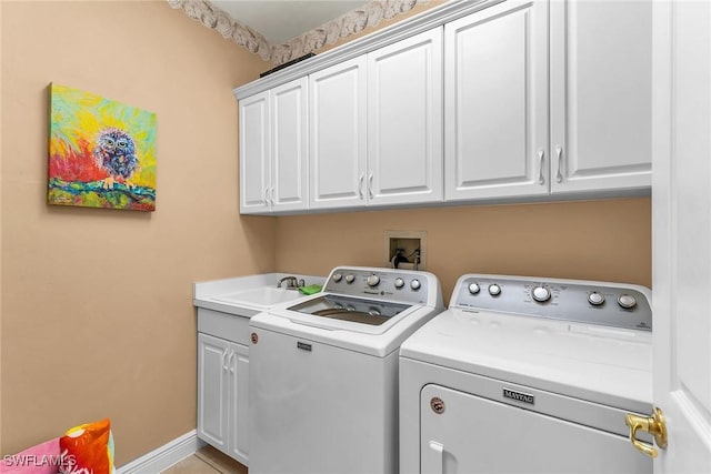 clothes washing area featuring washing machine and clothes dryer, baseboards, light tile patterned floors, cabinet space, and a sink
