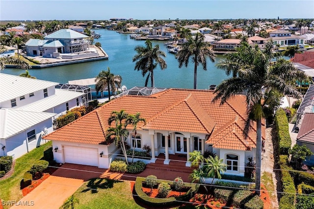 drone / aerial view featuring a residential view and a water view