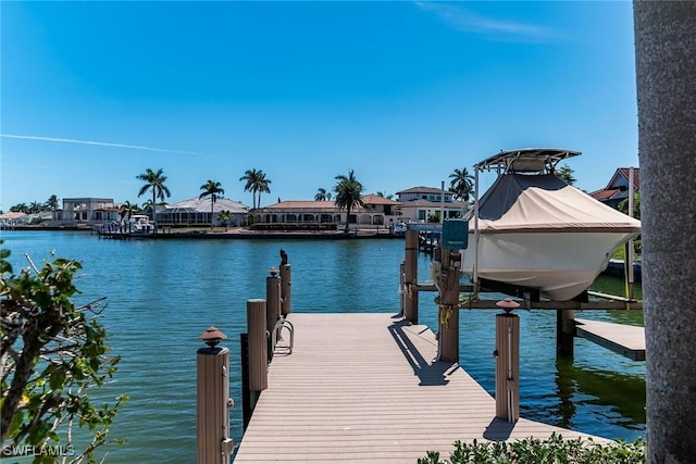 dock area with a water view and boat lift