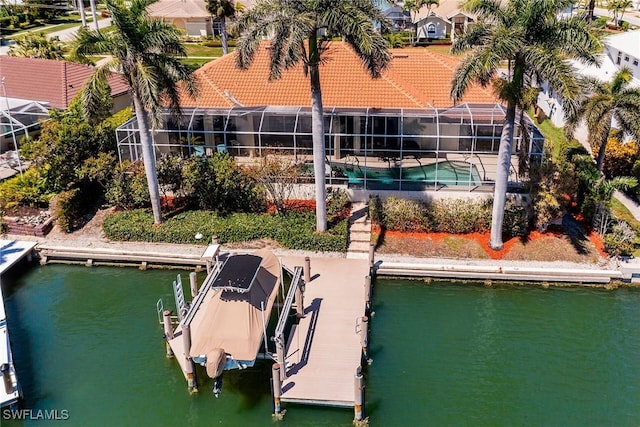 view of dock featuring glass enclosure, an outdoor pool, a water view, and boat lift