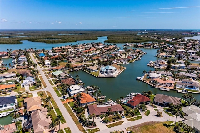 drone / aerial view featuring a residential view and a water view
