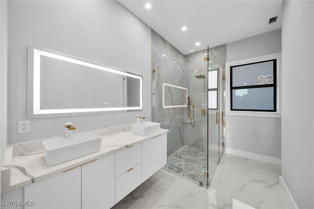 bathroom with a marble finish shower, marble finish floor, and a sink