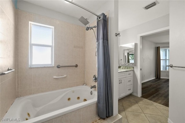 2218 NE 5th Ter, Cape Coral, FL 33909 - bathroom with vanity, tile patterned flooring, a combined bath / shower with jetted tub, and visible vents