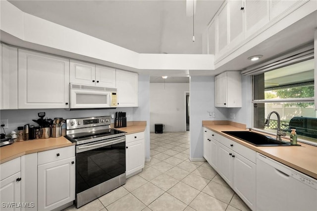 2218 NE 5th Ter, Cape Coral, FL 33909 - kitchen with white cabinets, white appliances, light countertops, and a sink