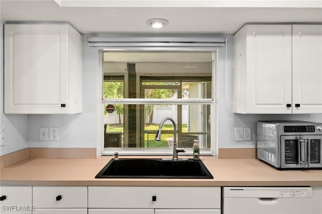 2218 NE 5th Ter, Cape Coral, FL 33909 - kitchen featuring stainless steel microwave, light countertops, white cabinetry, white dishwasher, and a sink
