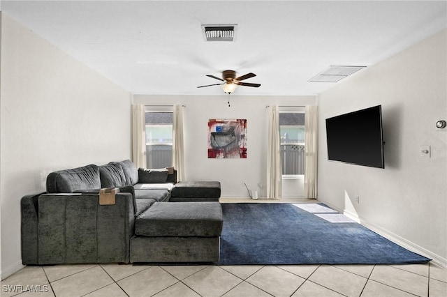 2218 NE 5th Ter, Cape Coral, FL 33909 - living room with visible vents, baseboards, a ceiling fan, and light tile patterned floors