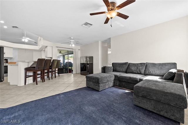 2218 NE 5th Ter, Cape Coral, FL 33909 - living area with light tile patterned floors, visible vents, and ceiling fan