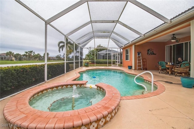 20854 Wheelock Dr, North Fort Myers, FL 33917 - view of swimming pool featuring glass enclosure, a pool with connected hot tub, a patio, and ceiling fan