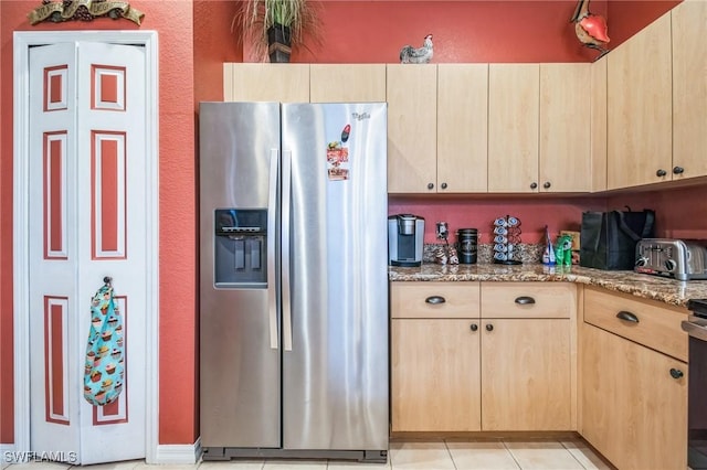 20854 Wheelock Dr, North Fort Myers, FL 33917 - kitchen with light brown cabinetry, light tile patterned floors, light stone countertops, and stainless steel fridge with ice dispenser