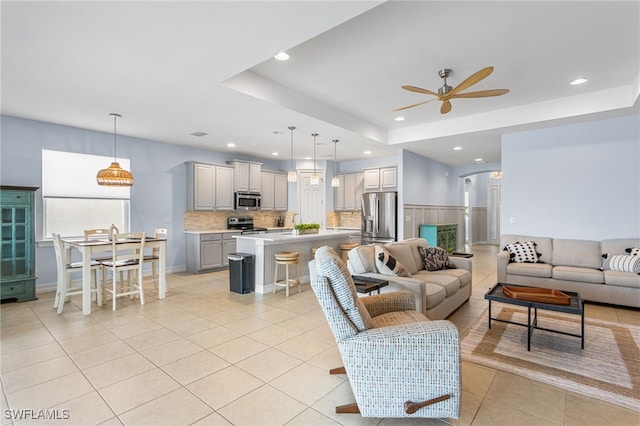 13104 Silver Thorn Loop, North Fort Myers, FL 33903 - living area featuring ceiling fan, light tile patterned floors, a raised ceiling, and recessed lighting
