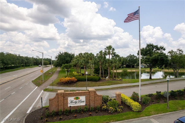 13104 Silver Thorn Loop, North Fort Myers, FL 33903 - view of asphalt street featuring street lighting, sidewalks, a water view, and view of wooded area