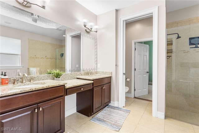 13104 Silver Thorn Loop, North Fort Myers, FL 33903 - bathroom with vanity, a tile shower, tile patterned flooring, and toilet